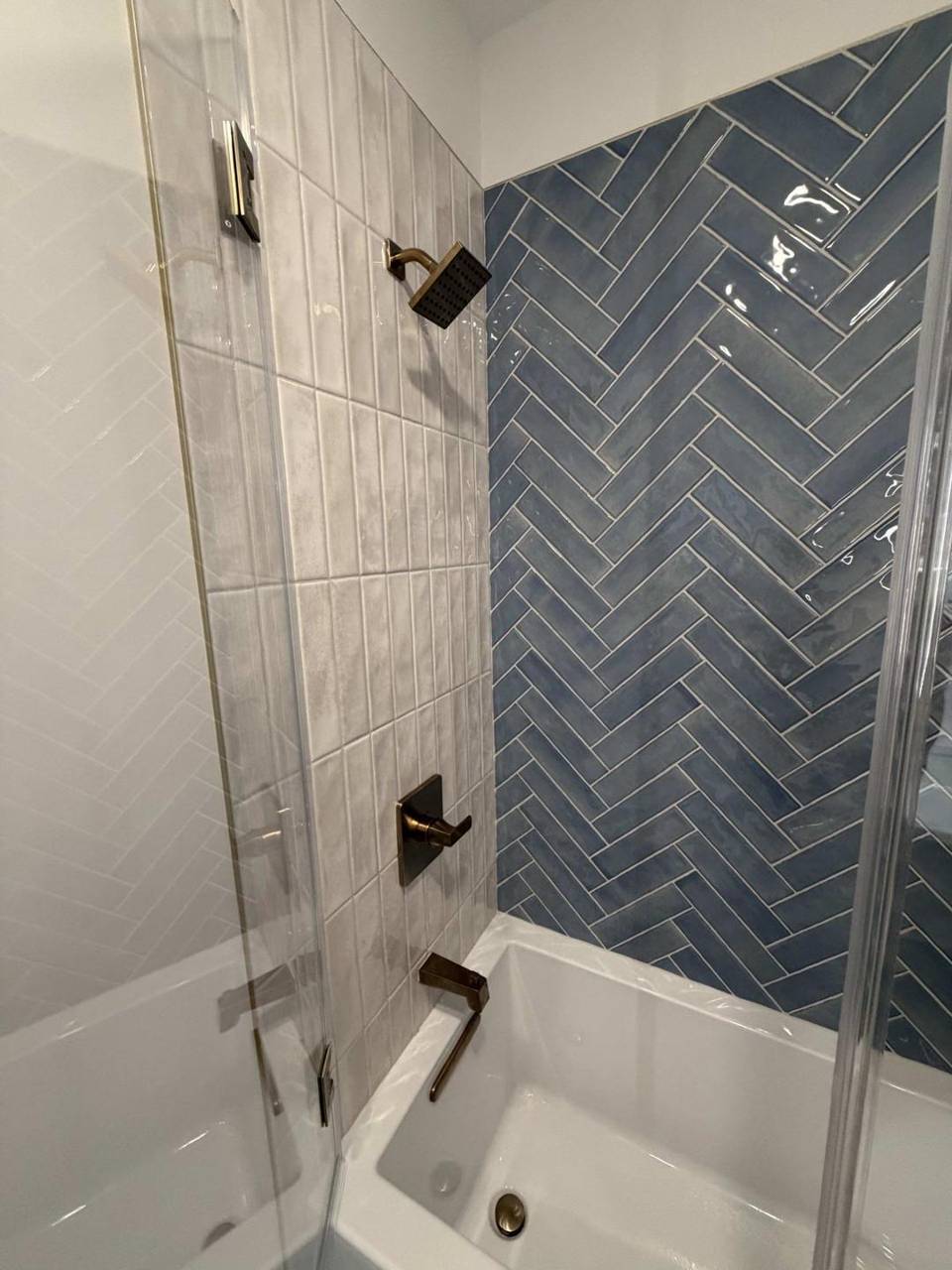 Herringbone tile shower wall detail