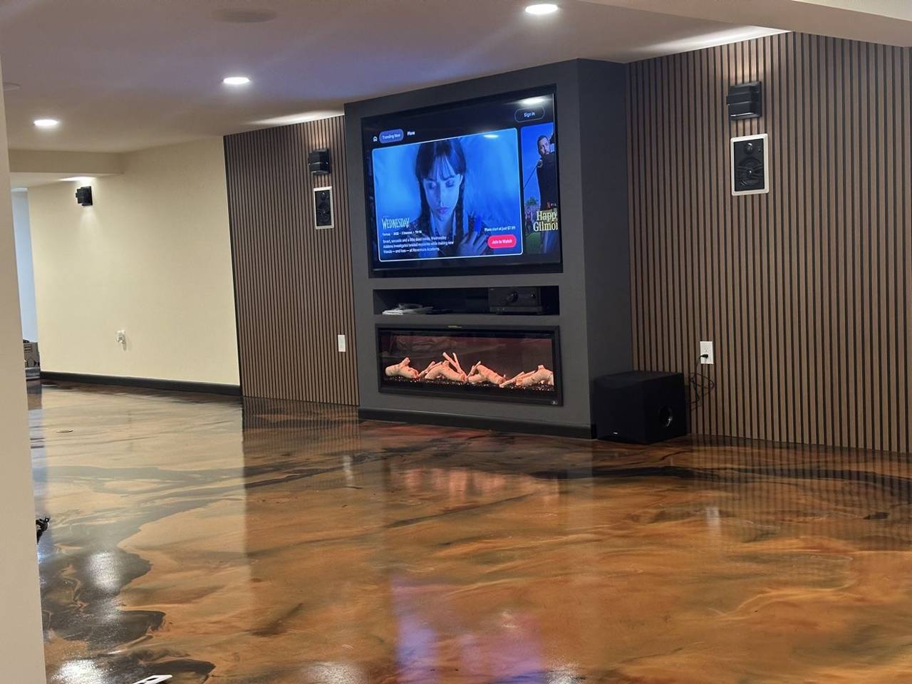 Media wall with fireplace in a finished basement